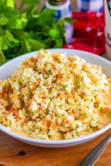 A bowl of creamy copycat KFC coleslaw with finely chopped cabbage and carrots.