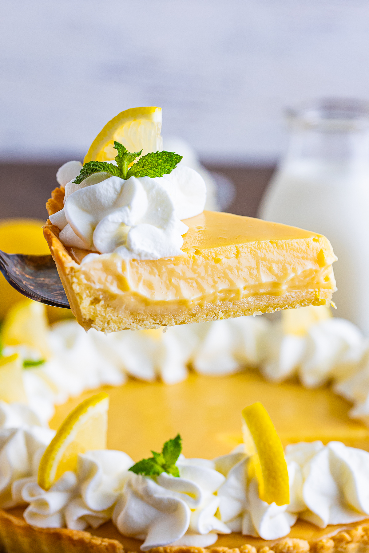 a cake server with a piece of Lemonade Tart in air