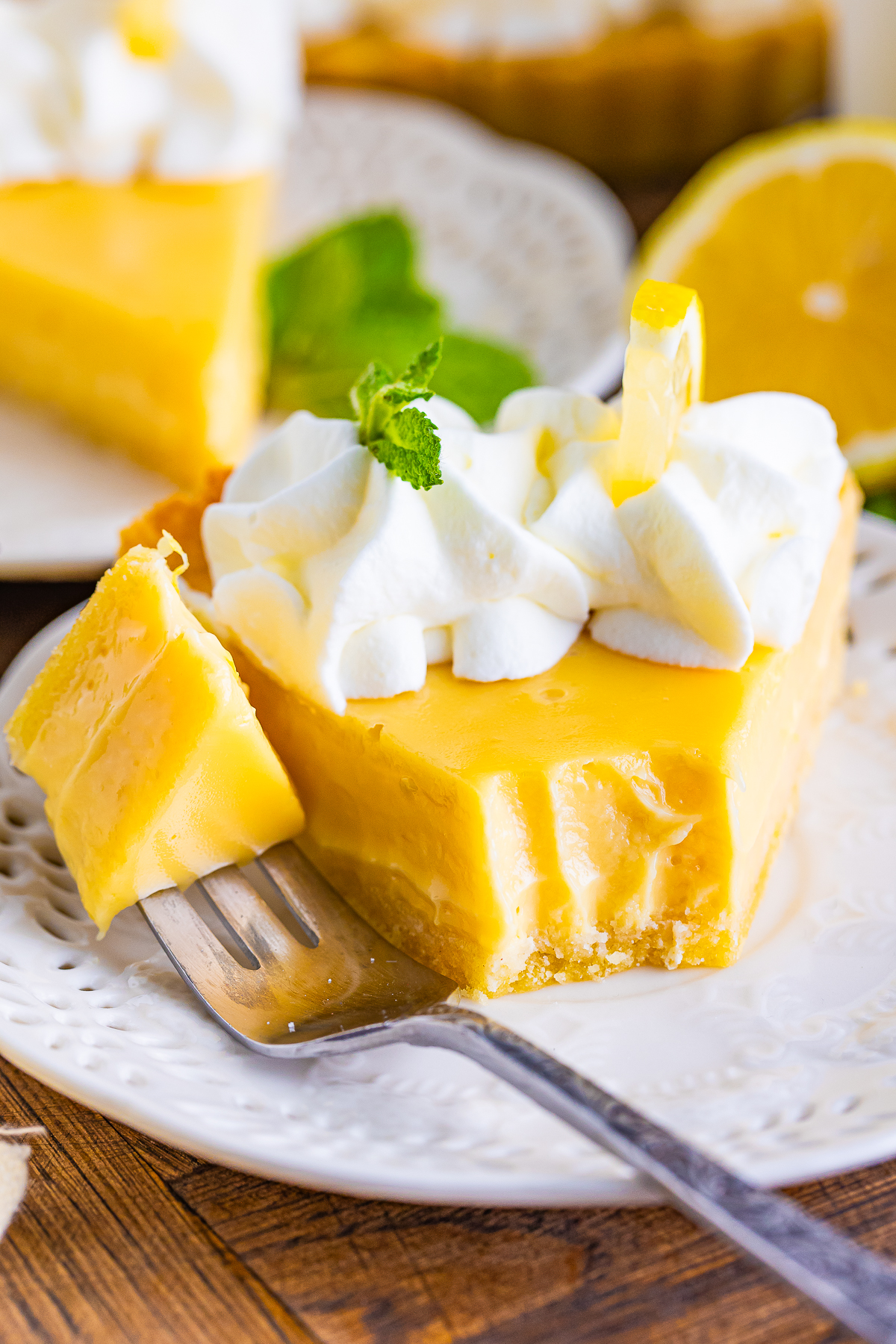a piece of Lemonade Tart on a plate with a bite taken out