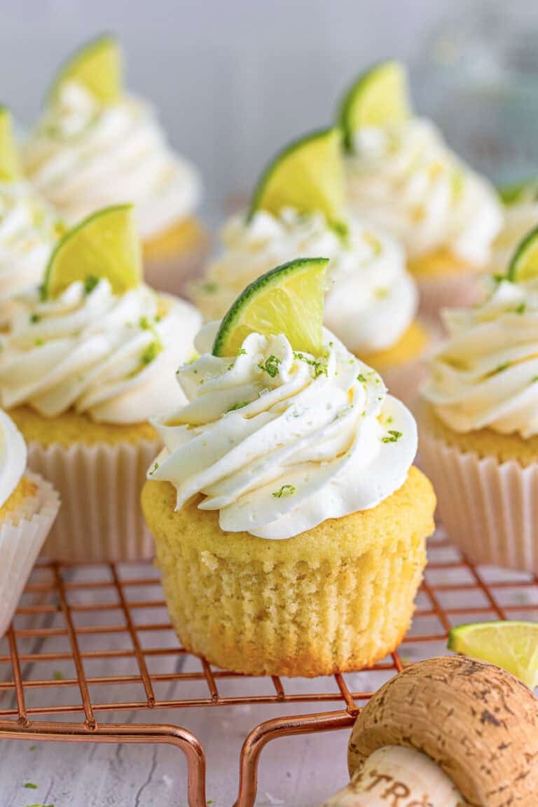 Margarita Cupcakes topped with swirled tequila buttercream, lime zest, and a fresh lime wedge.
