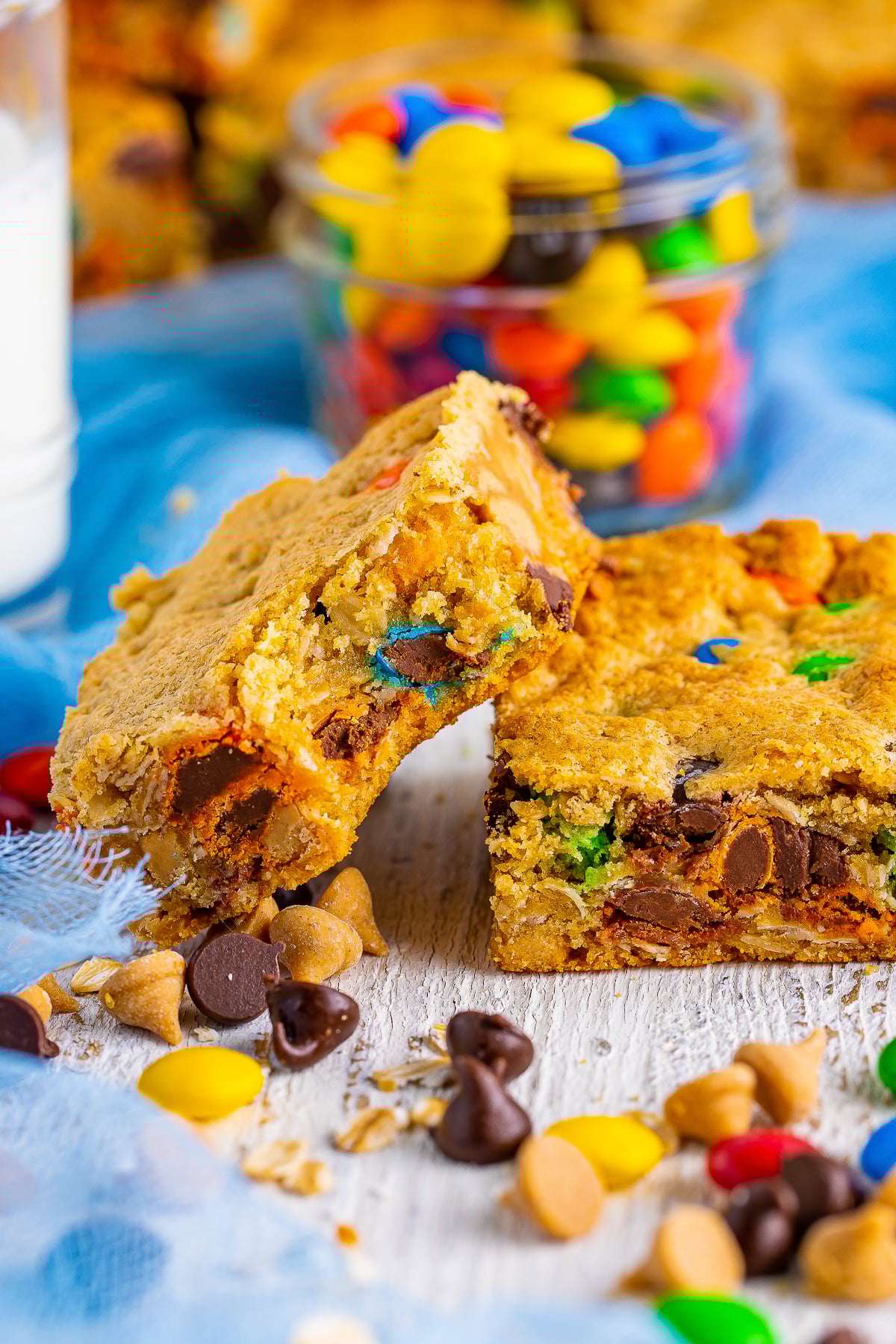 a Monster Cookie Bars with a bite taken out leaning against another bar