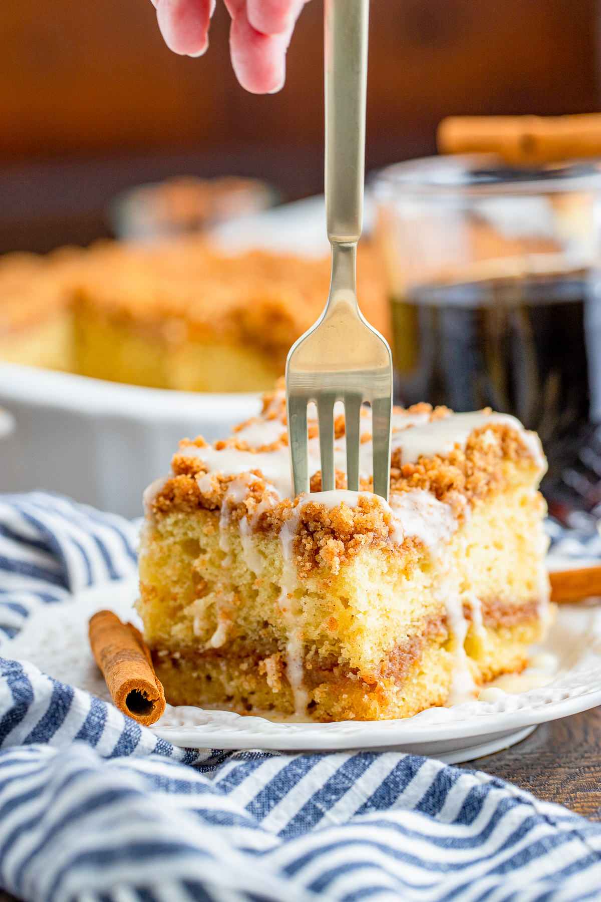 a fork getting a bite out of a piece of Sour Cream Coffee Cake