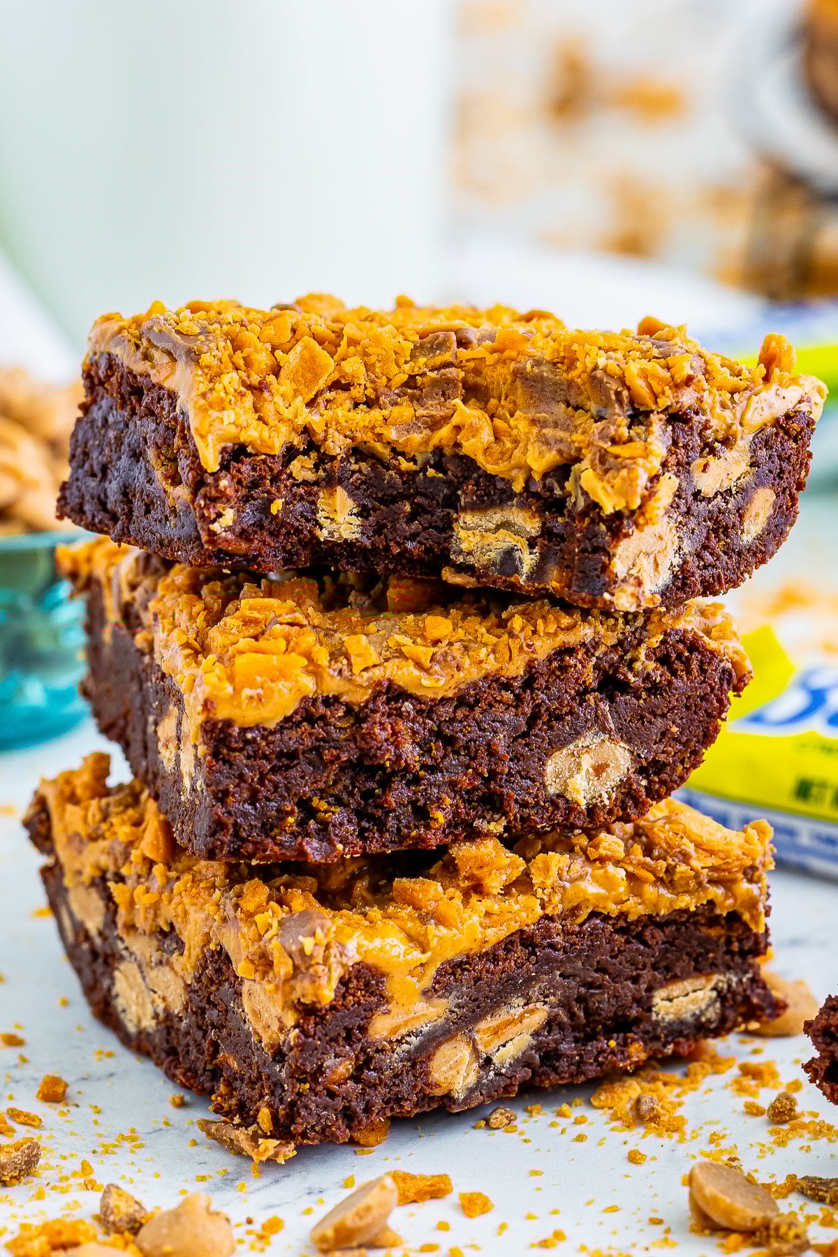 three Butterfinger Brownies stacked on top of each other, the one on top has a bite taken out