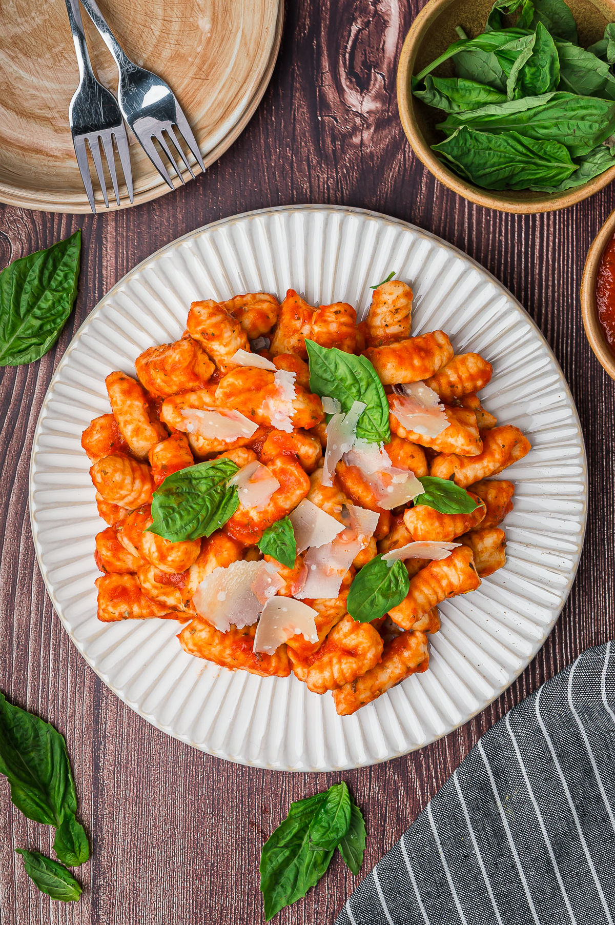 overhead image of sauced Gnocchi on white plate