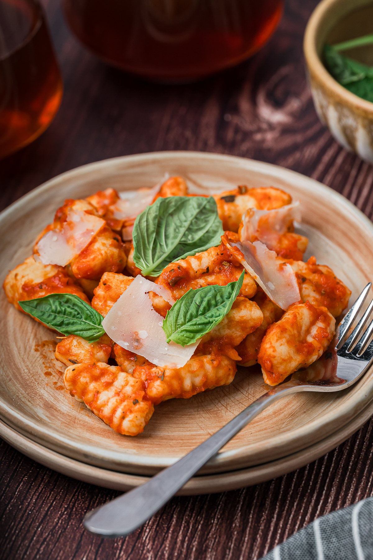 finished Gnocchi in red sauce on tan plate