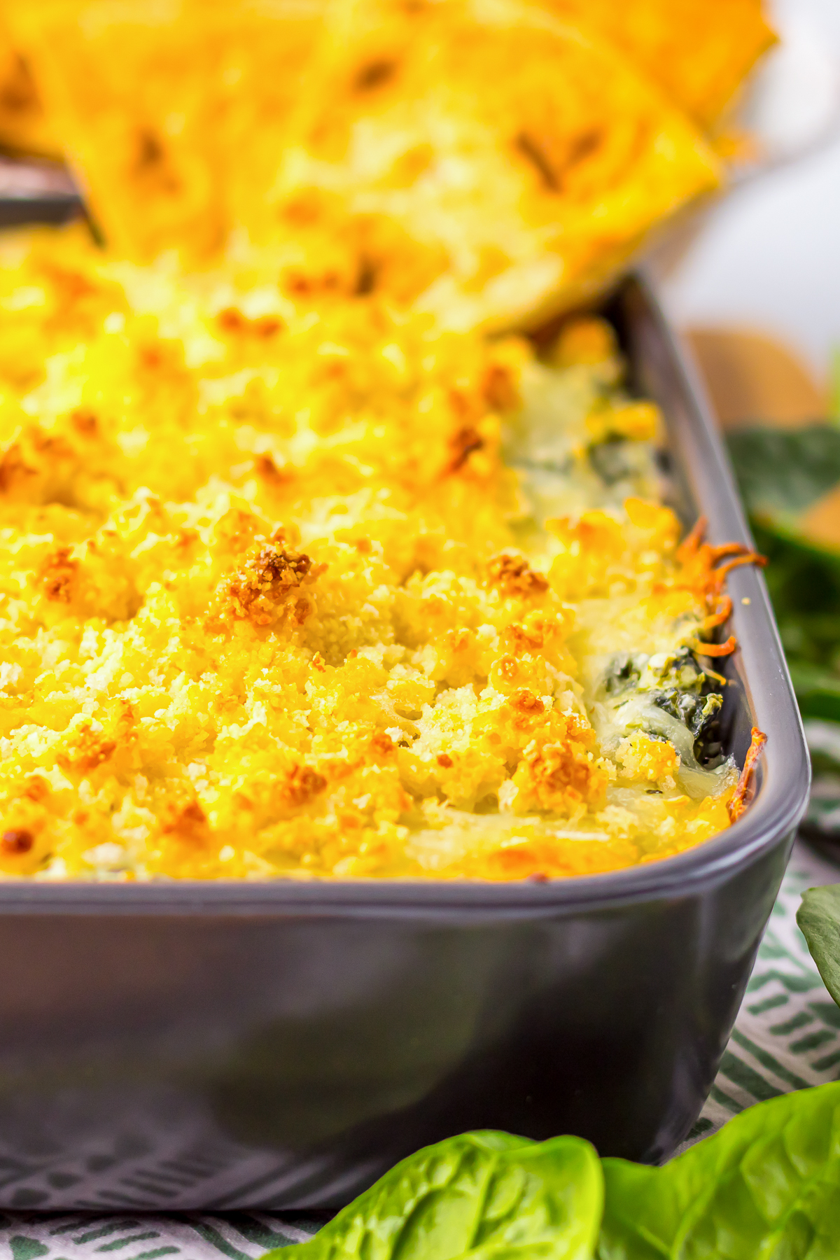 up close image of hot spinach dip in baking dish