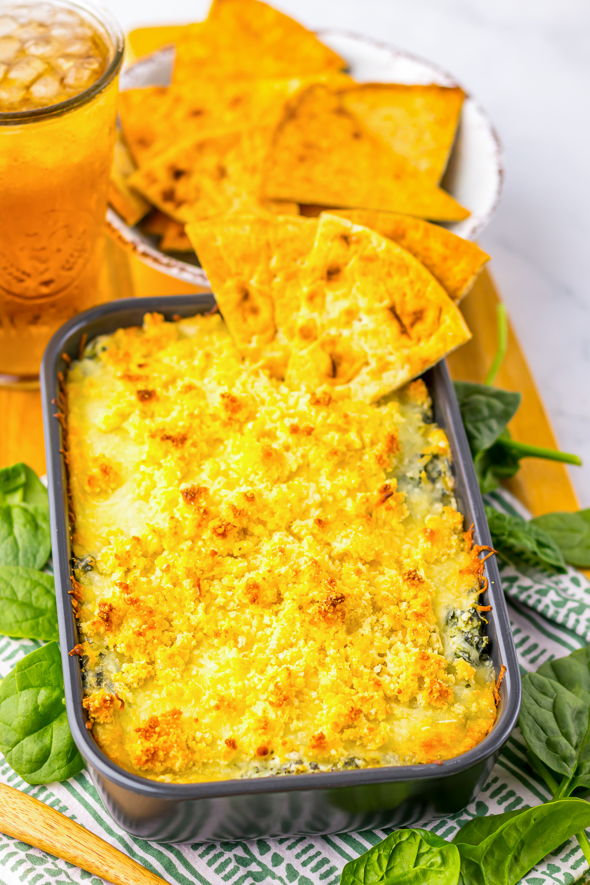 finished hot spinach dip in dish with pitas