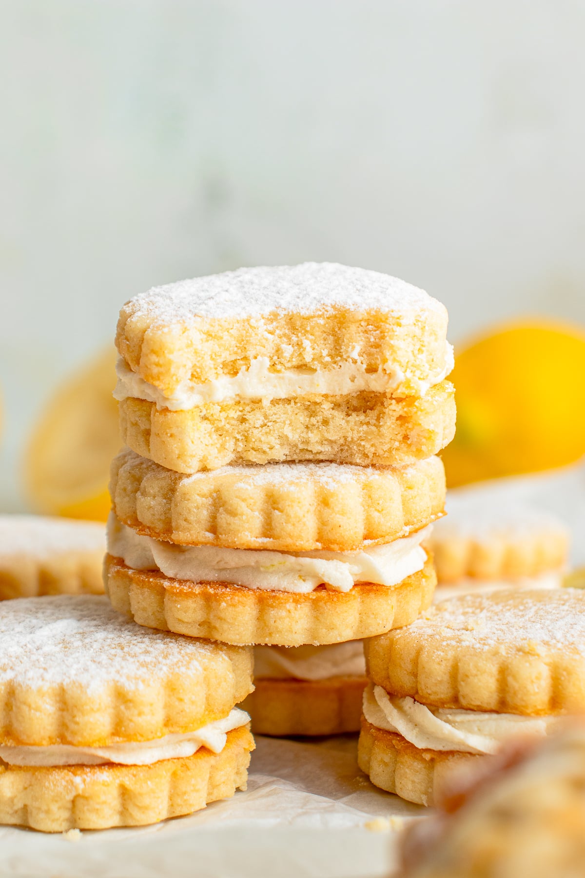 stacked Lemon Sandwich Cookies the one on top has a bite taken out