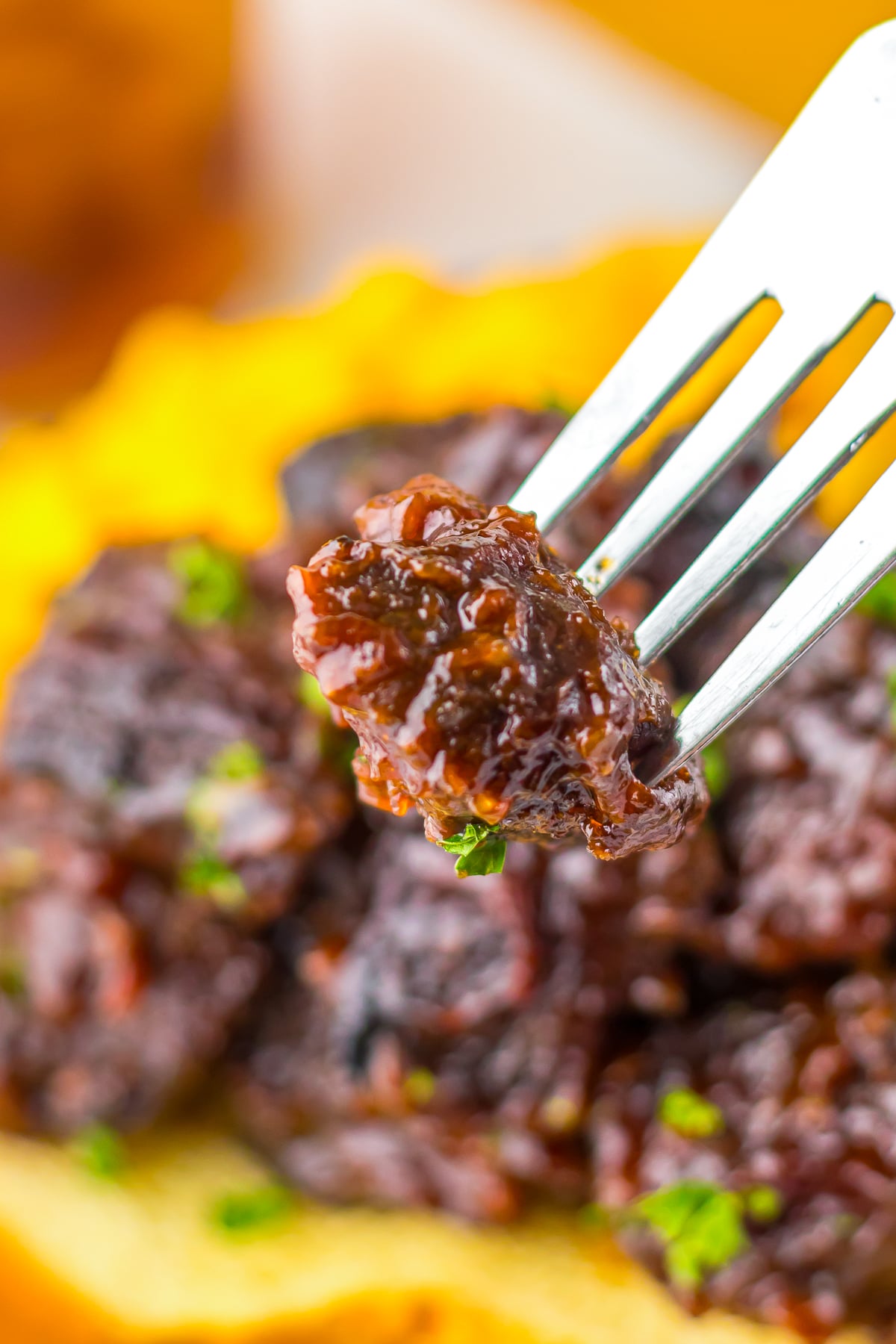 a fork holding up Chuck Roast Burnt Ends in air