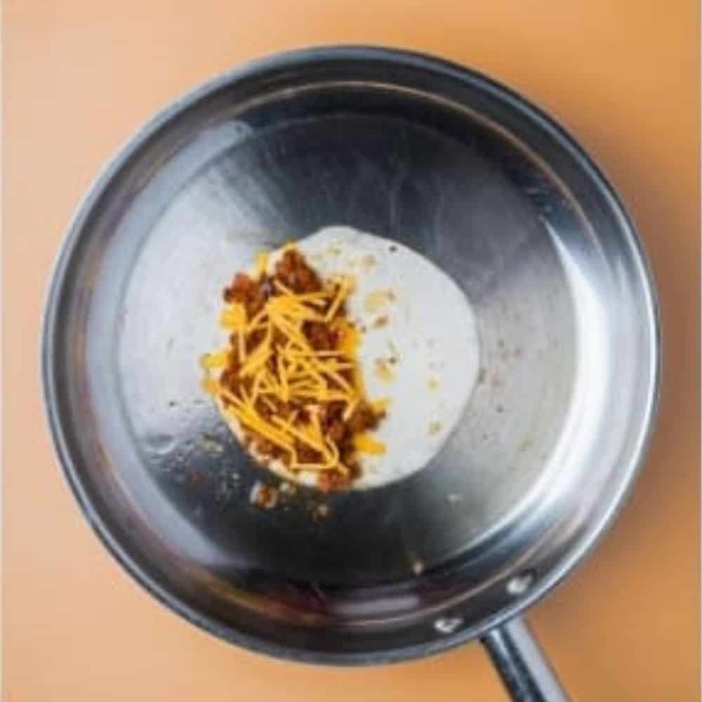 pan fried tortilla with a chorizo filling topped with cheese.