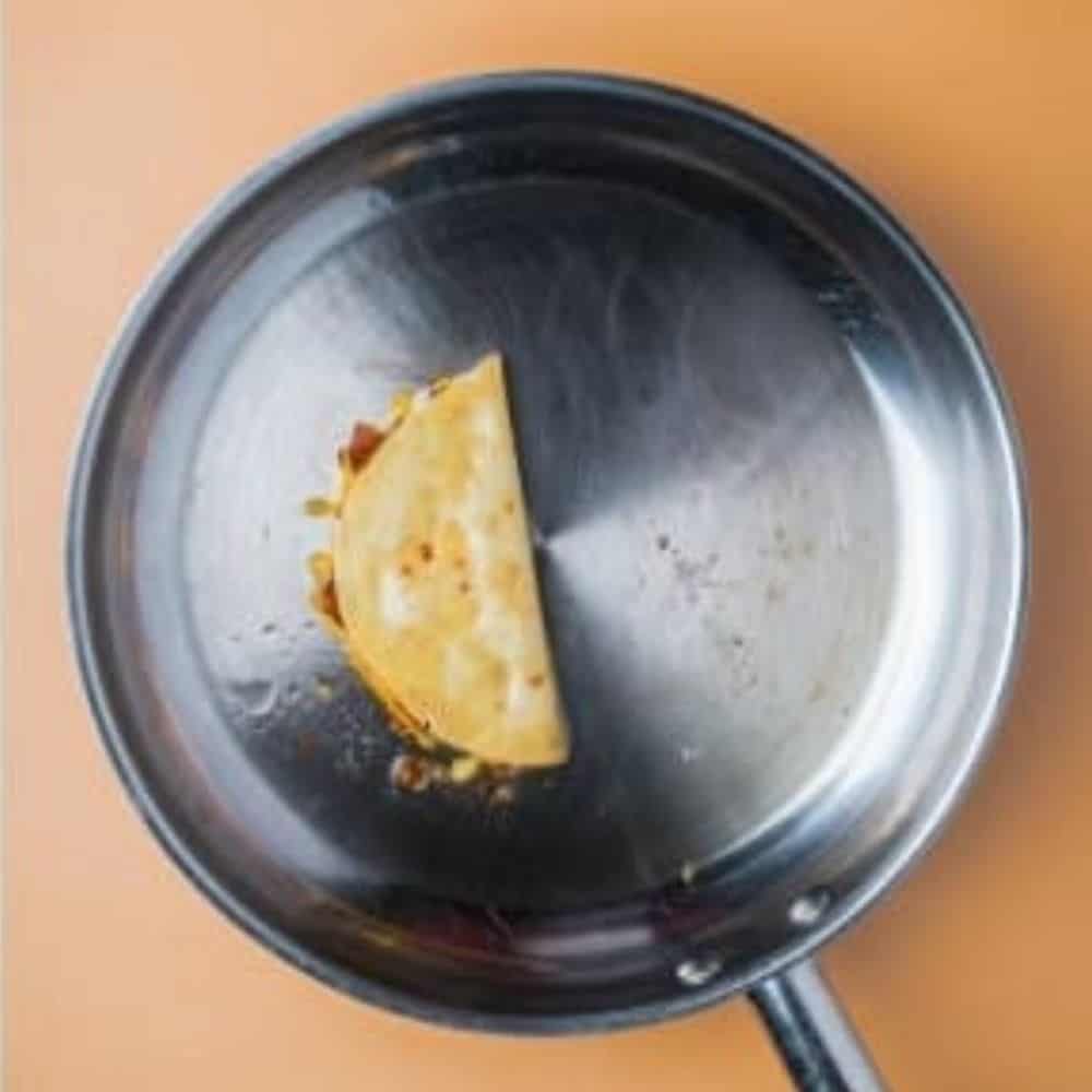 chorizo taco getting cooked in a saucepan.