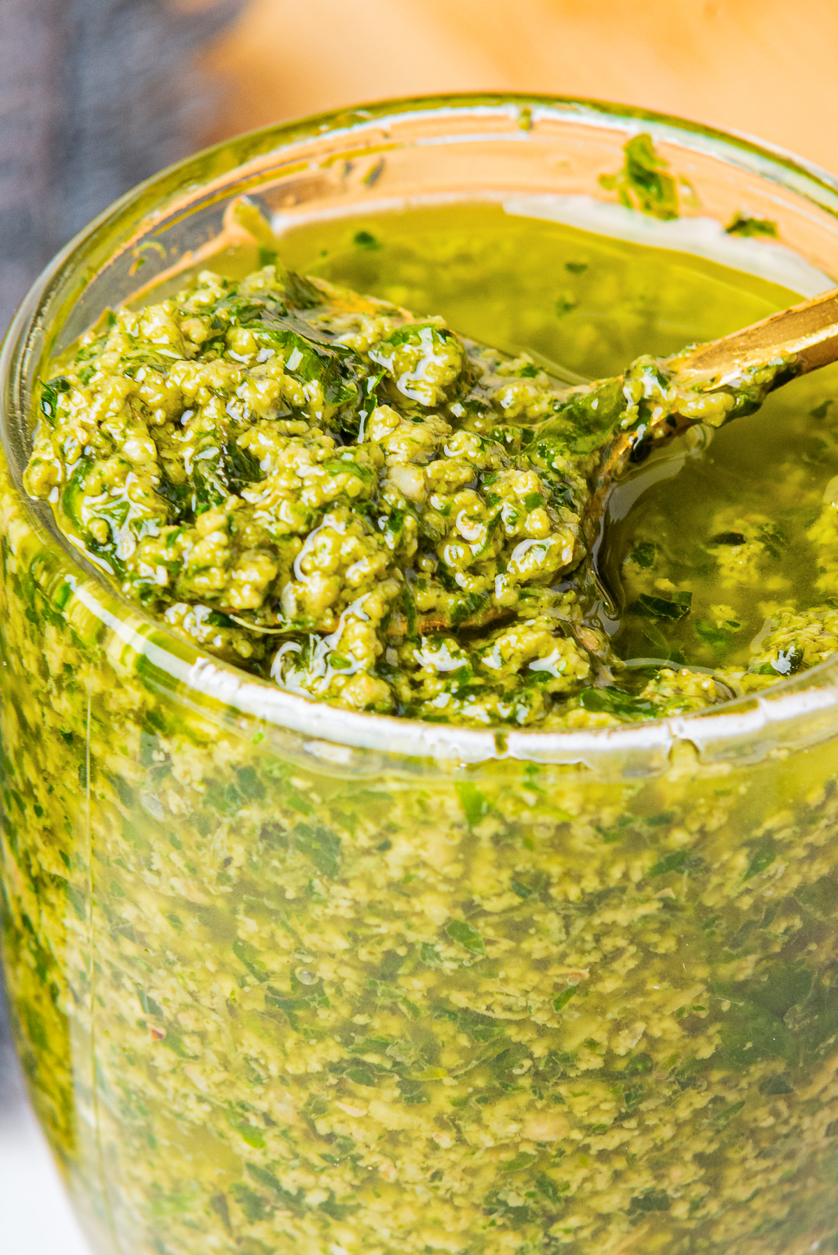 close up image of Pesto sauce with walnuts in glass jar
