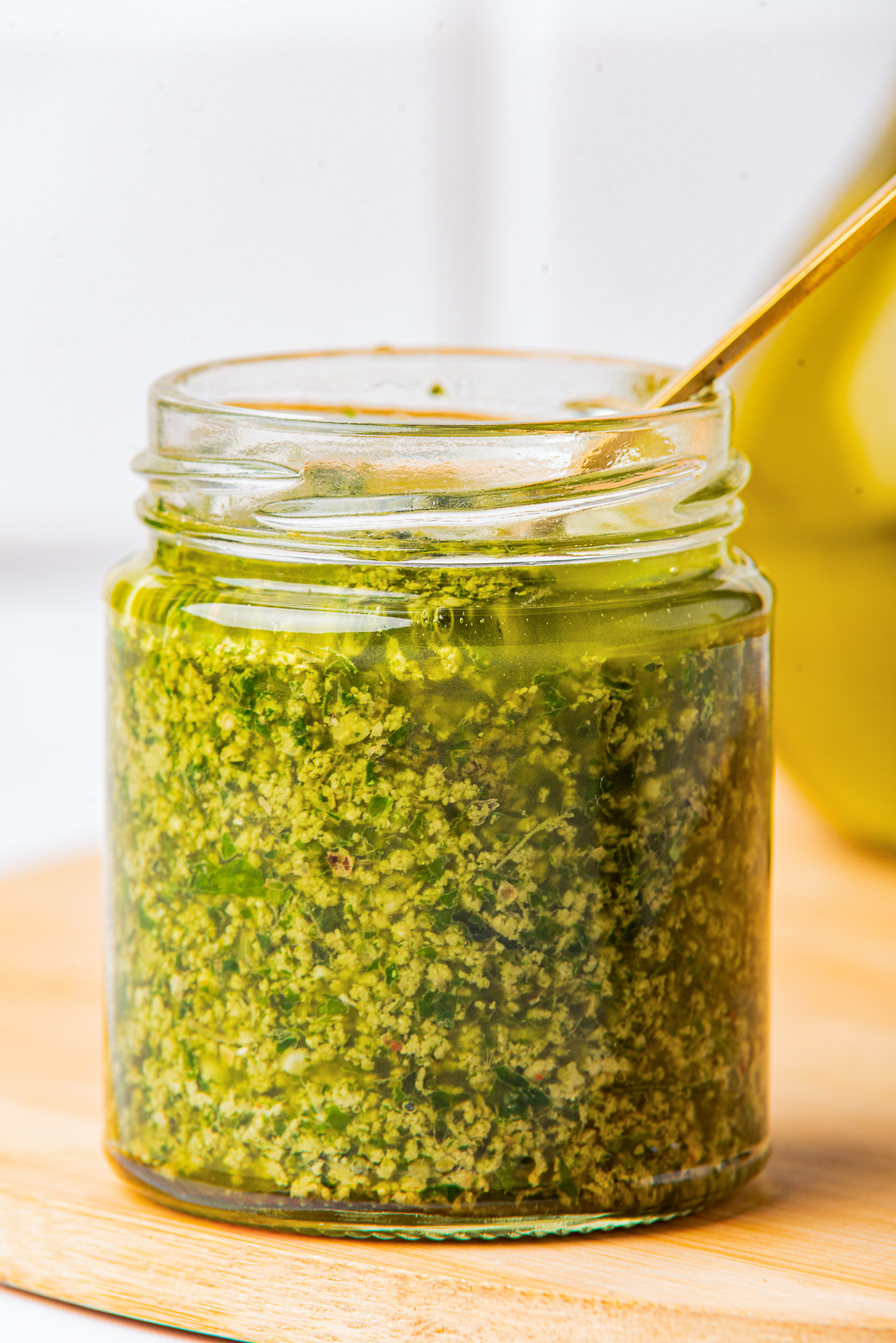 straight on shot of Pesto sauce with walnuts in glass jar