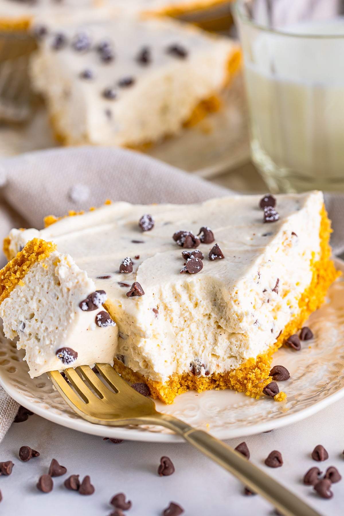 a slice of Cannoli Pie on a plate with a bite taken out