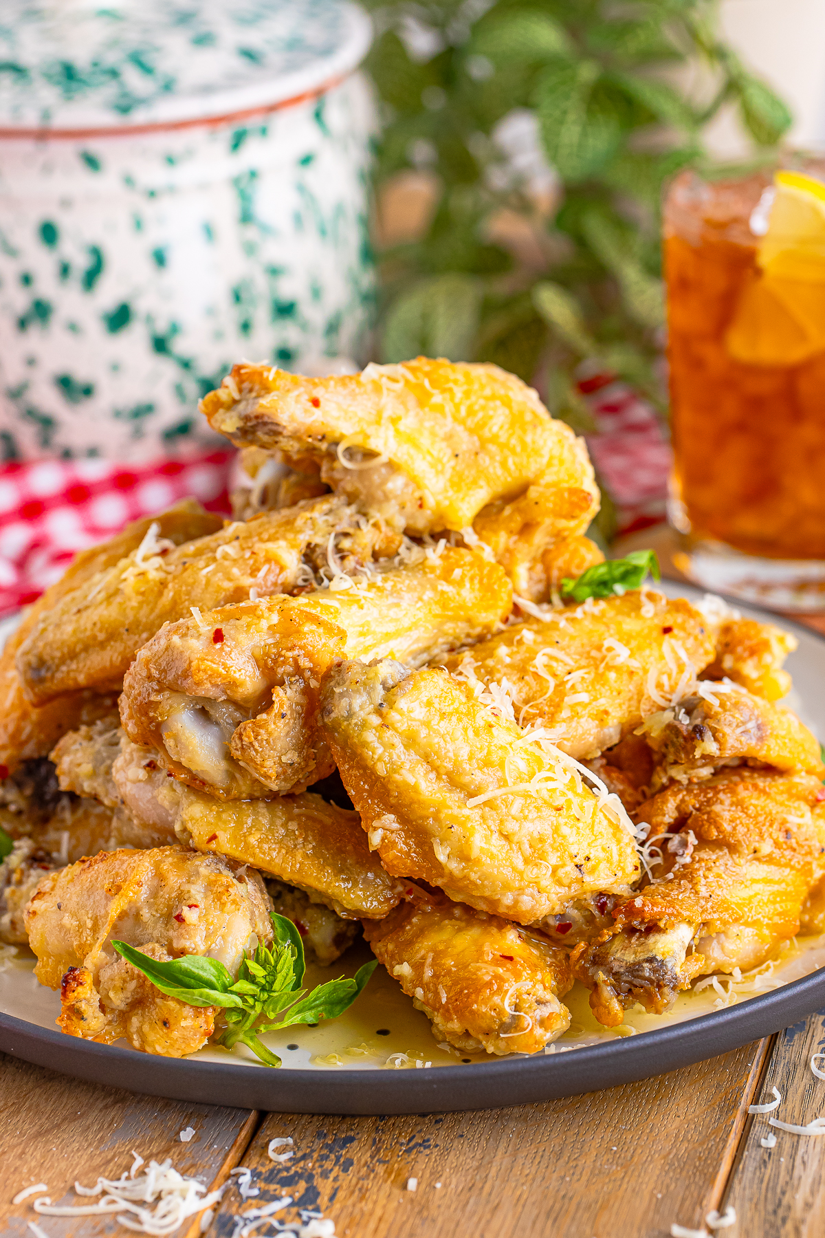 farther away image of Garlic Parmesan Hot Wings on a plate stacked high