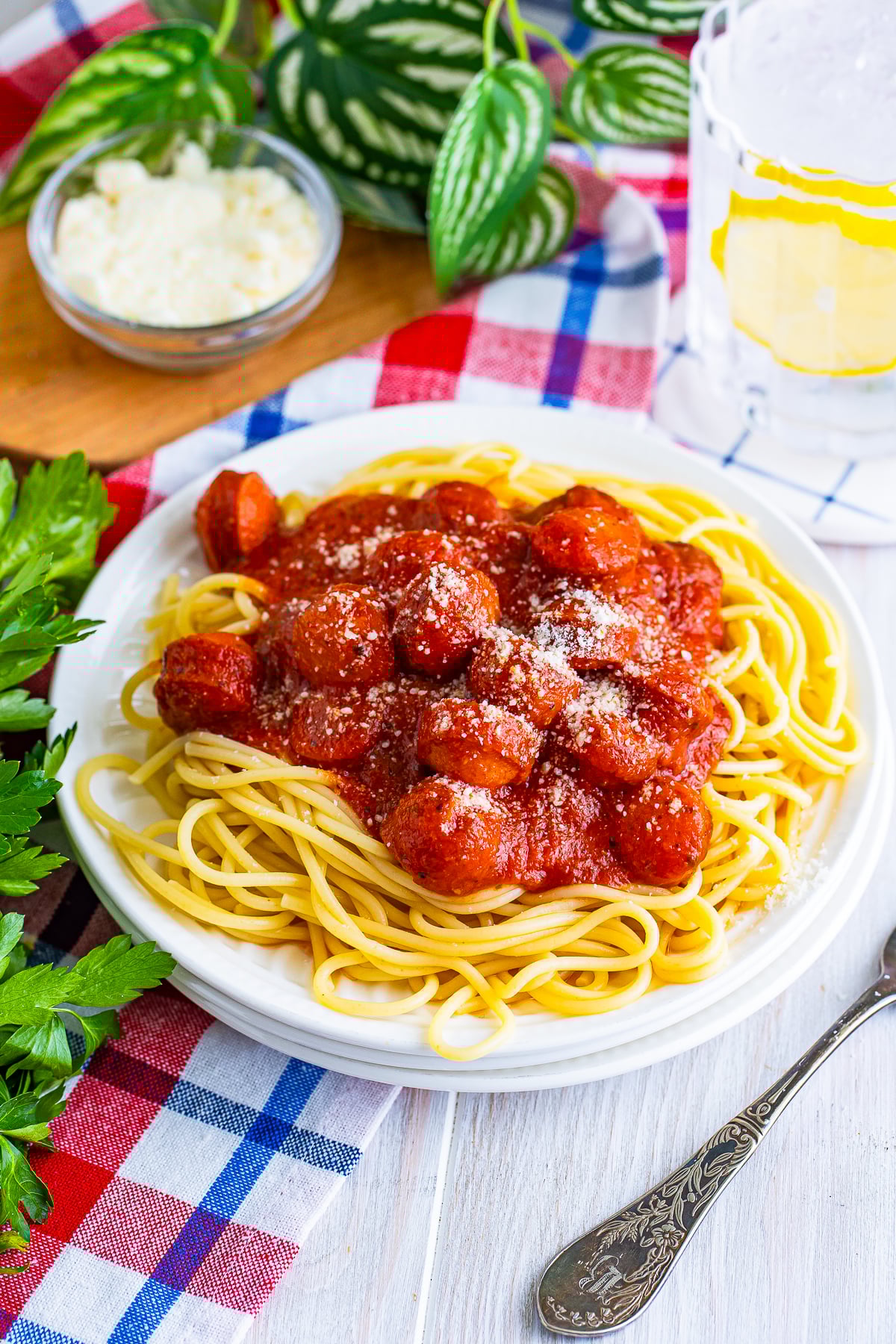 Hot Dogs Spaghetti served on a white plate