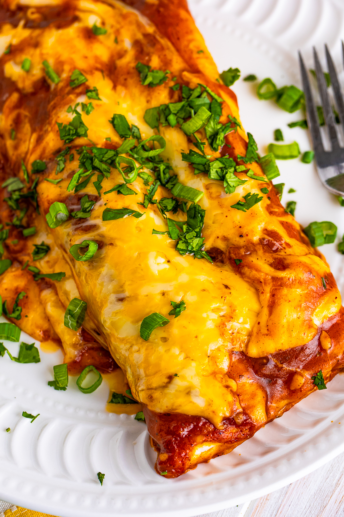 up close overhead image of Rotisserie Chicken Enchiladas on a plate