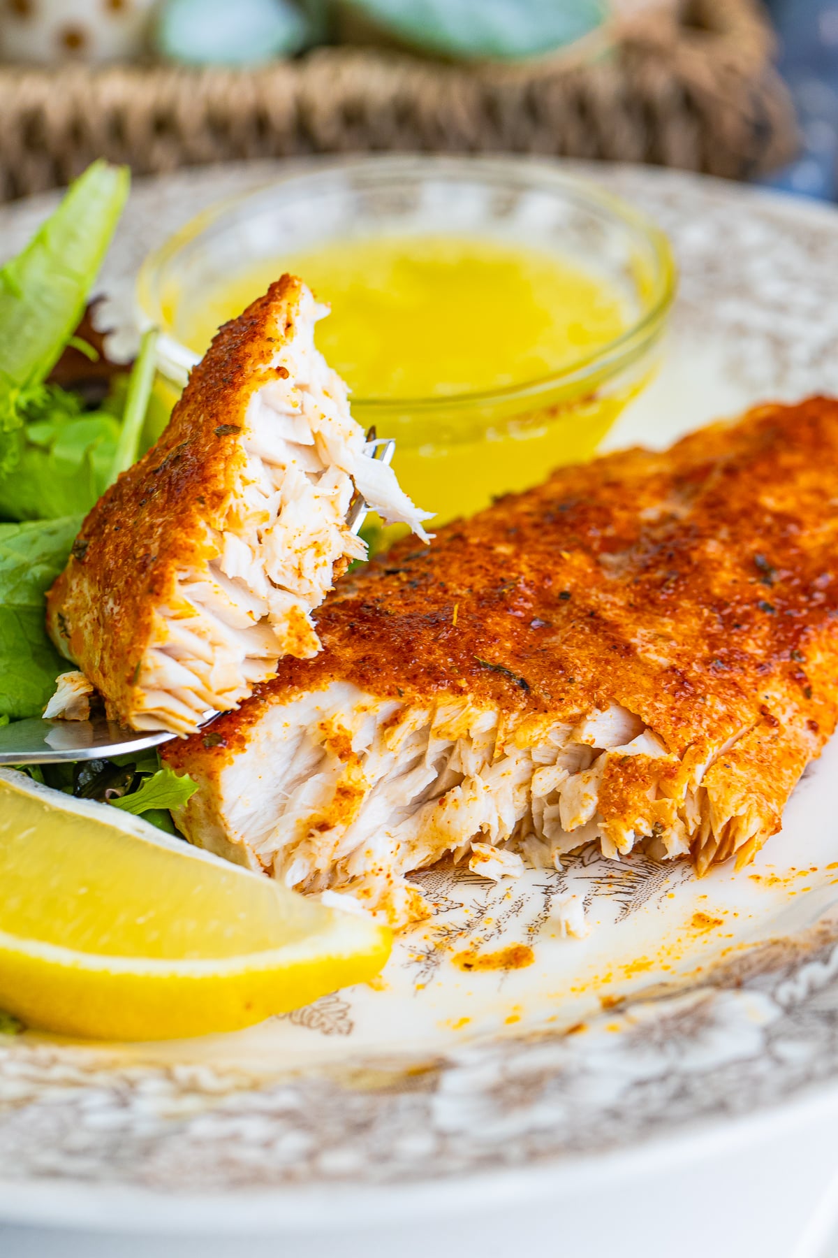 a piece of Baked Mahi Recipe on a plate with a bite taken out