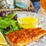 Baked Mahi Mahi fillets on a sheet pan with golden seasoning crust and melted butter.