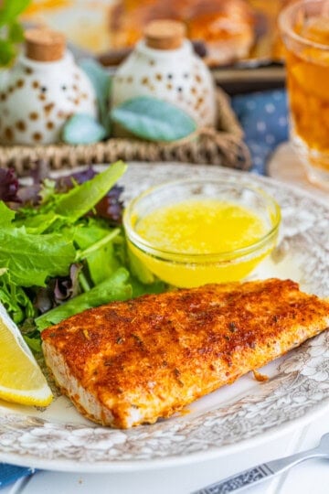 Baked Mahi Mahi fillets on a sheet pan with golden seasoning crust and melted butter.