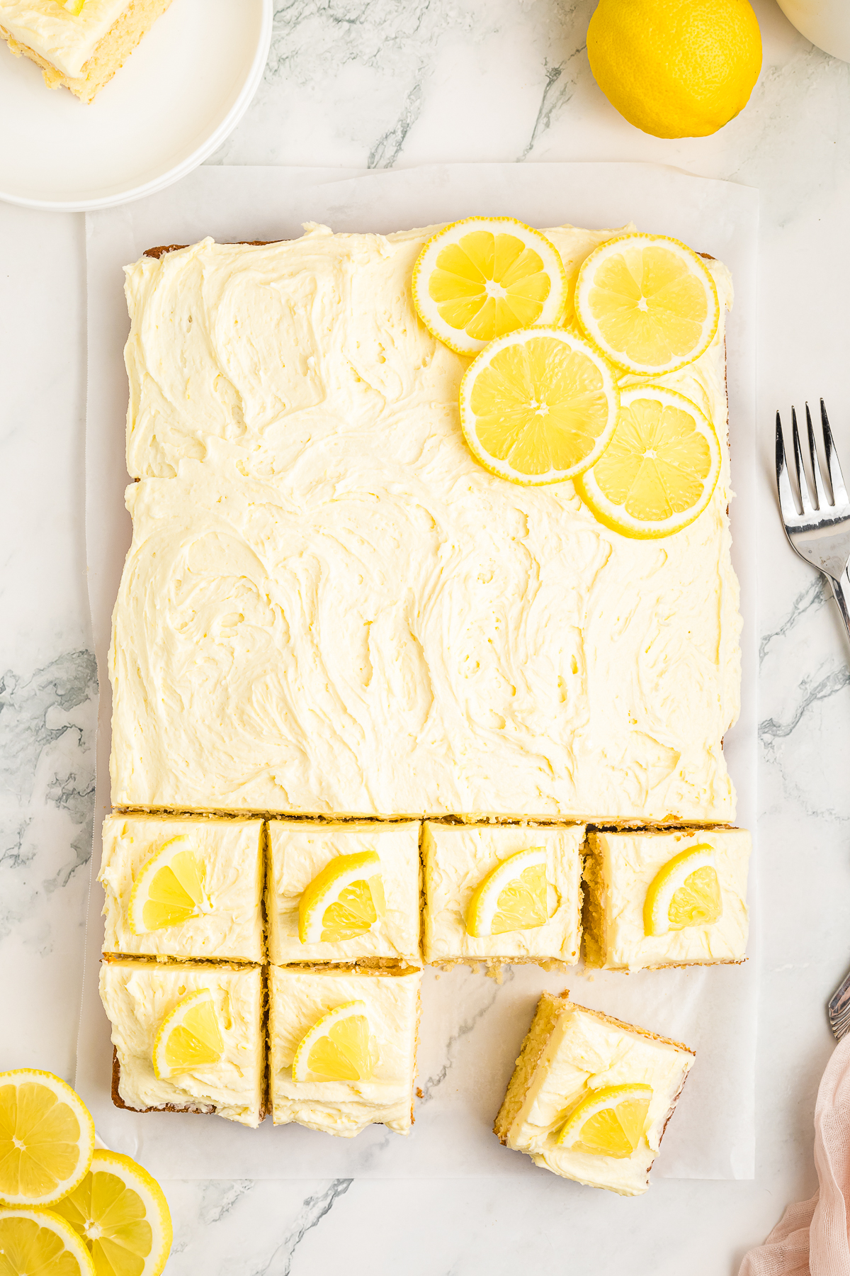 overhead image of finished Lemon Cake being cut into servings