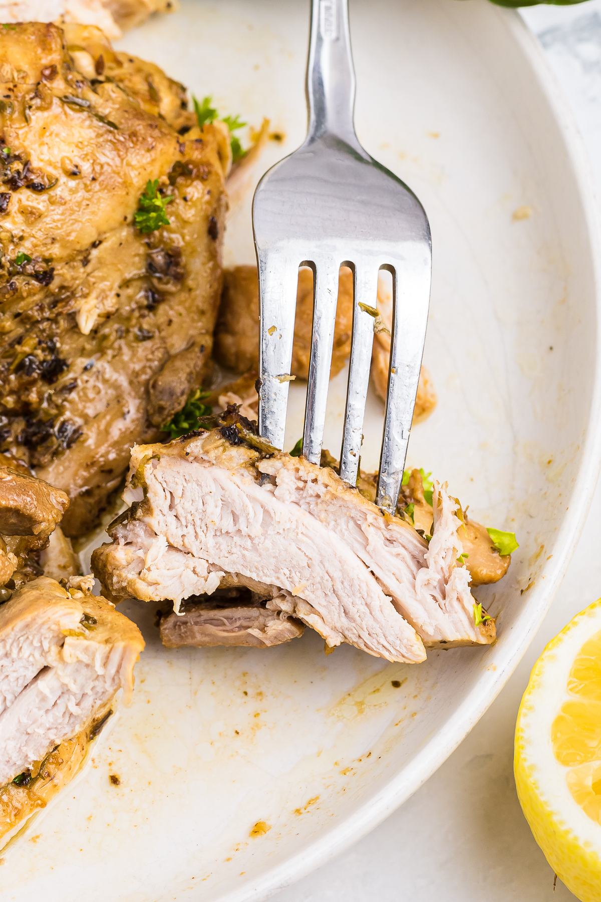 a fork with a bite of Marinaded Chicken Thighs on it