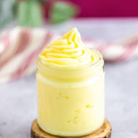 A jar of silky homemade pastry cream piped with a swirl on top.
