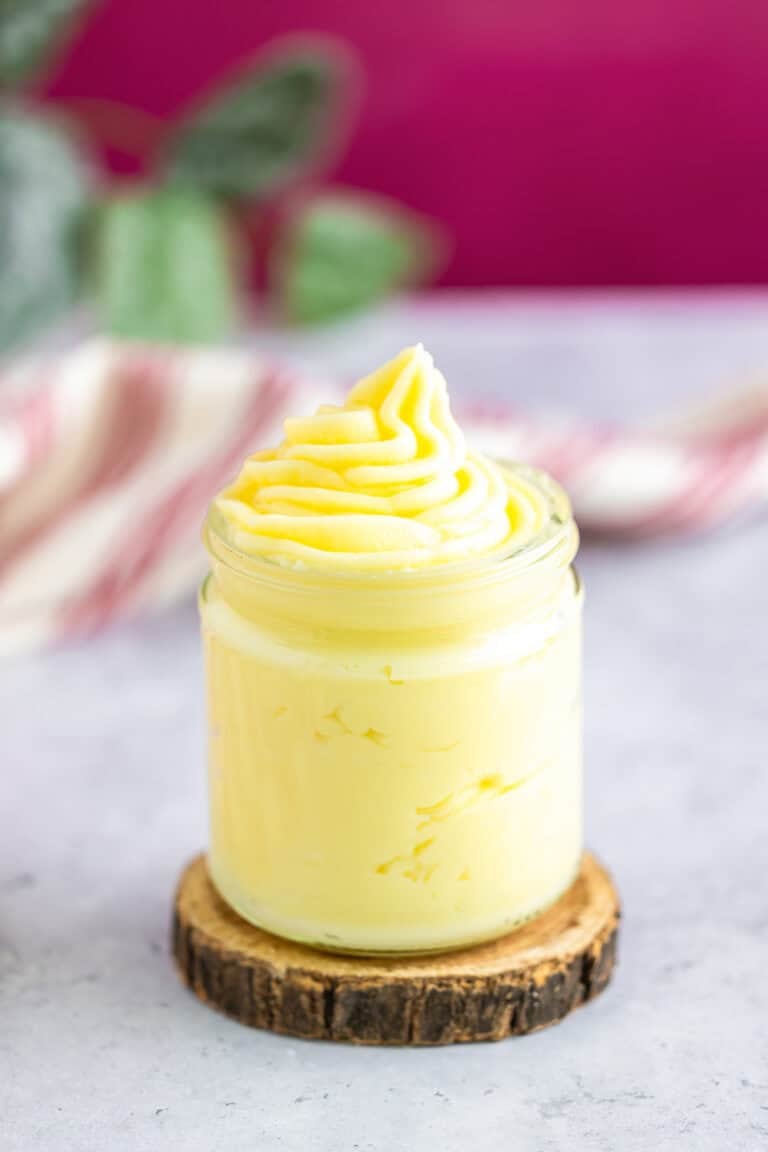 A jar of silky homemade pastry cream piped with a swirl on top.