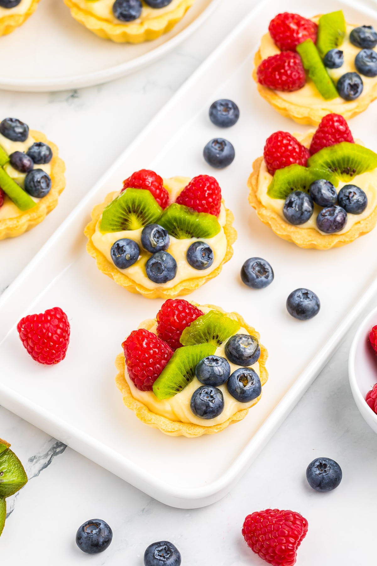 Fruit Tartlets served on a white rectangle plate