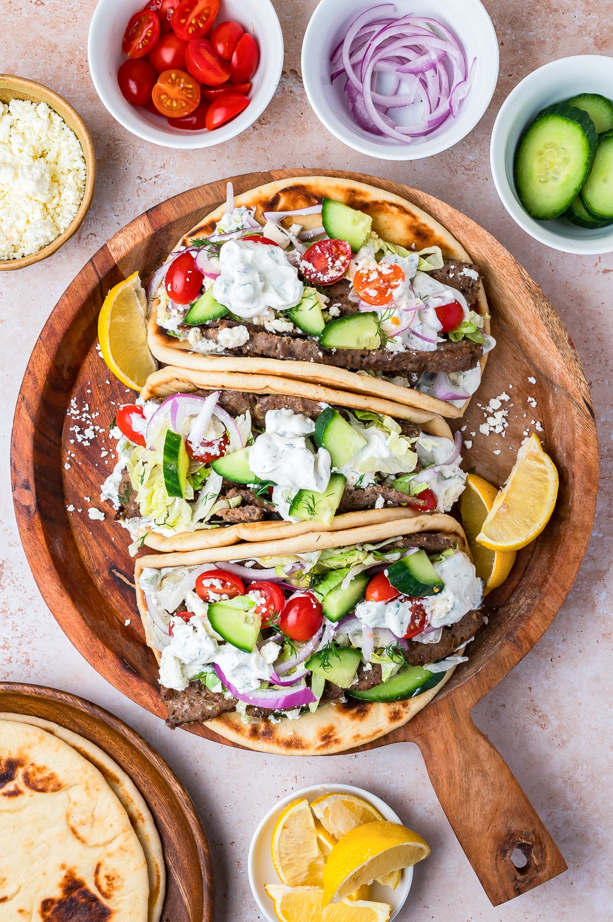 overhead image of 3 Gyros on a wooden serving tray