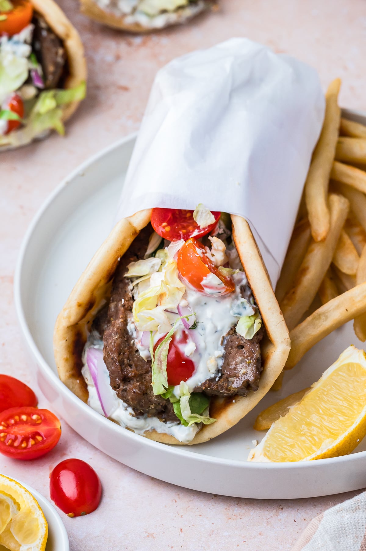 a Gyros on a white plate with fries