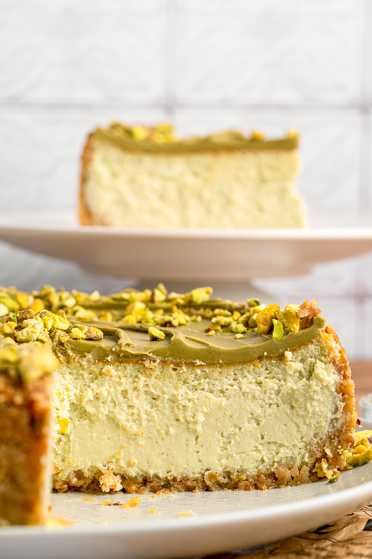 Pistachio Cheesecake with slices cut out to show the interior