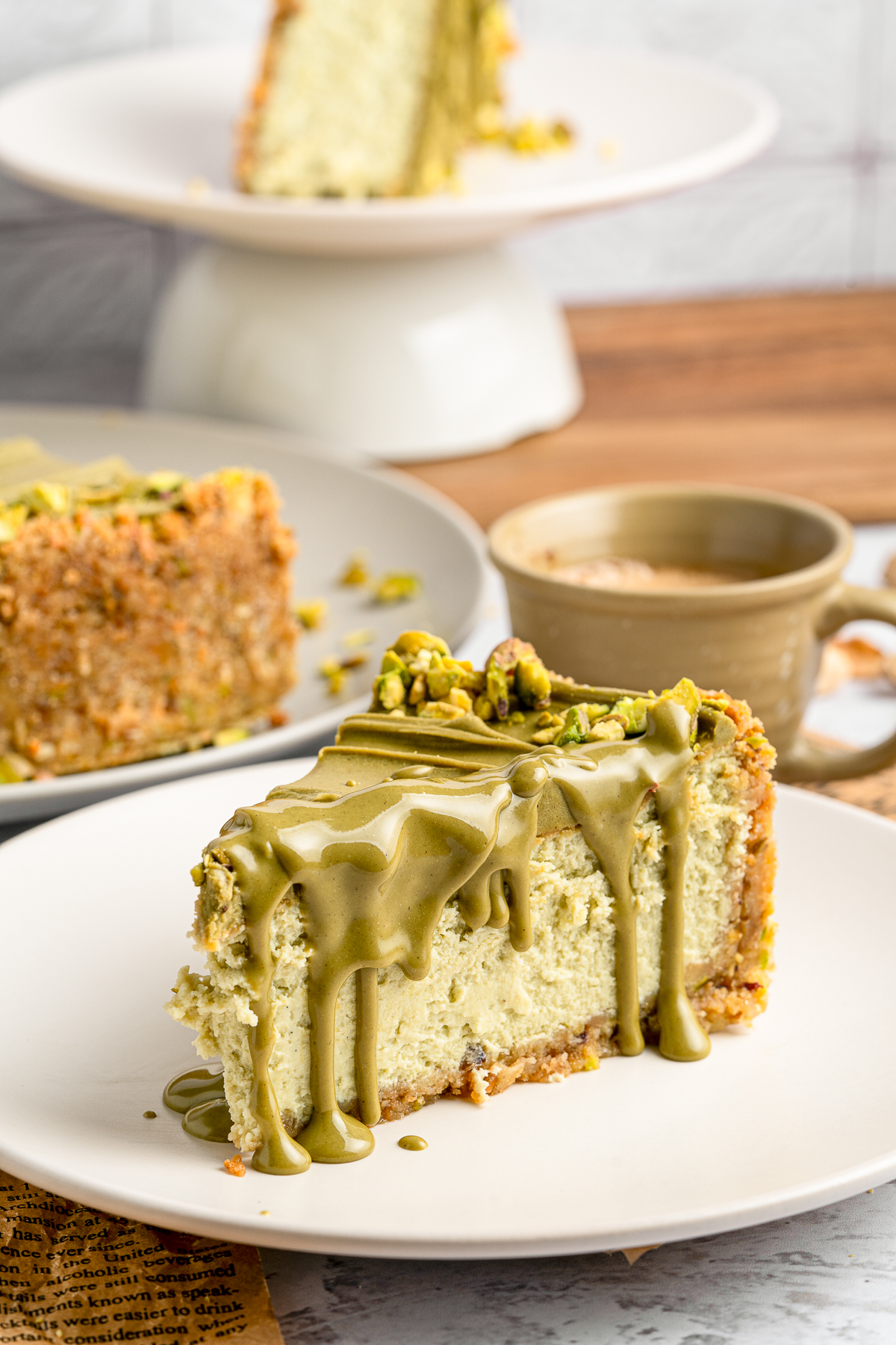 a slice of Pistachio Cheesecake on a white plate