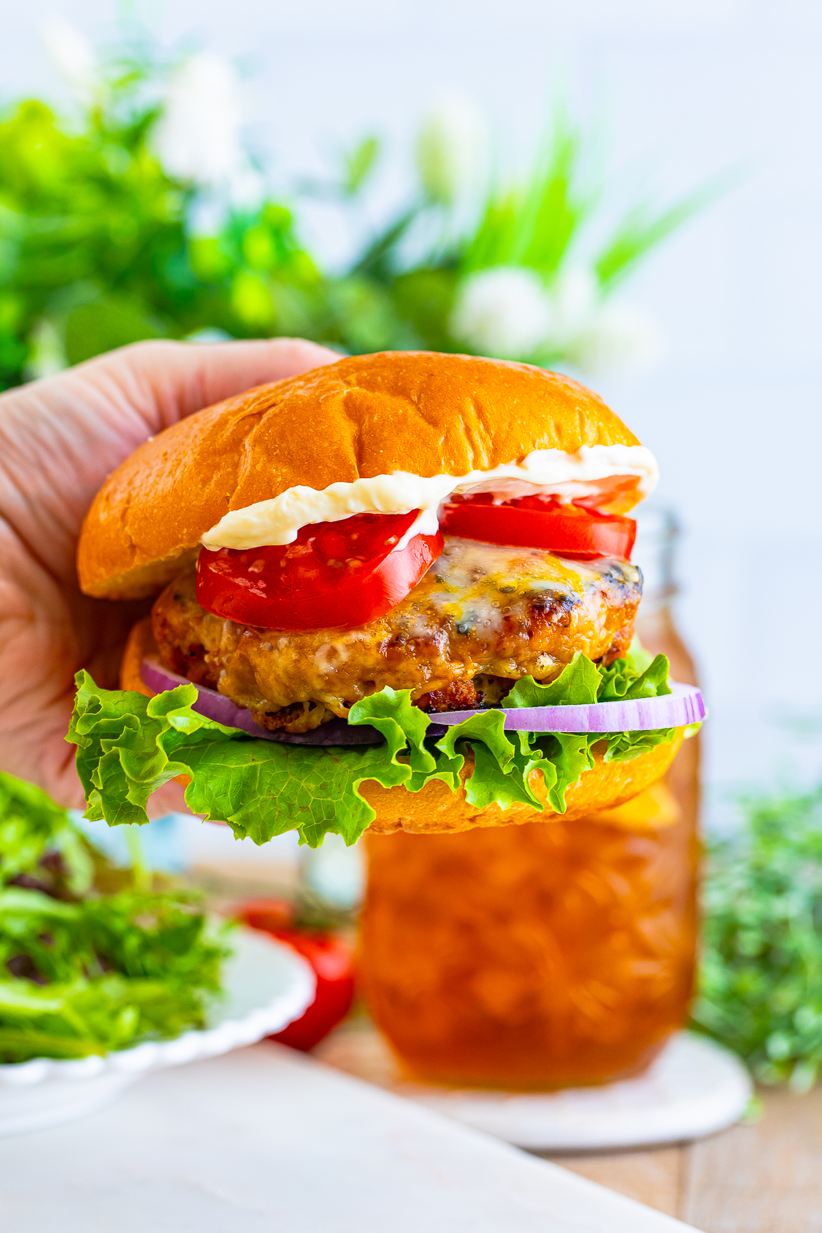 a hand holding up turkey burger recipe in air