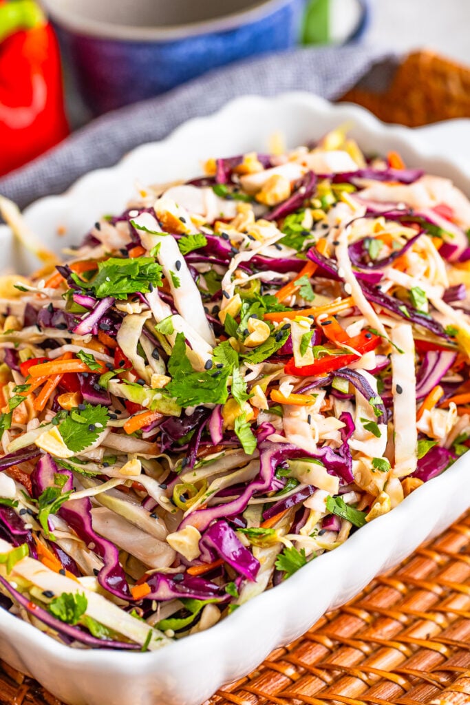 Asian Slaw Recipe served in a white bowl with garnishes