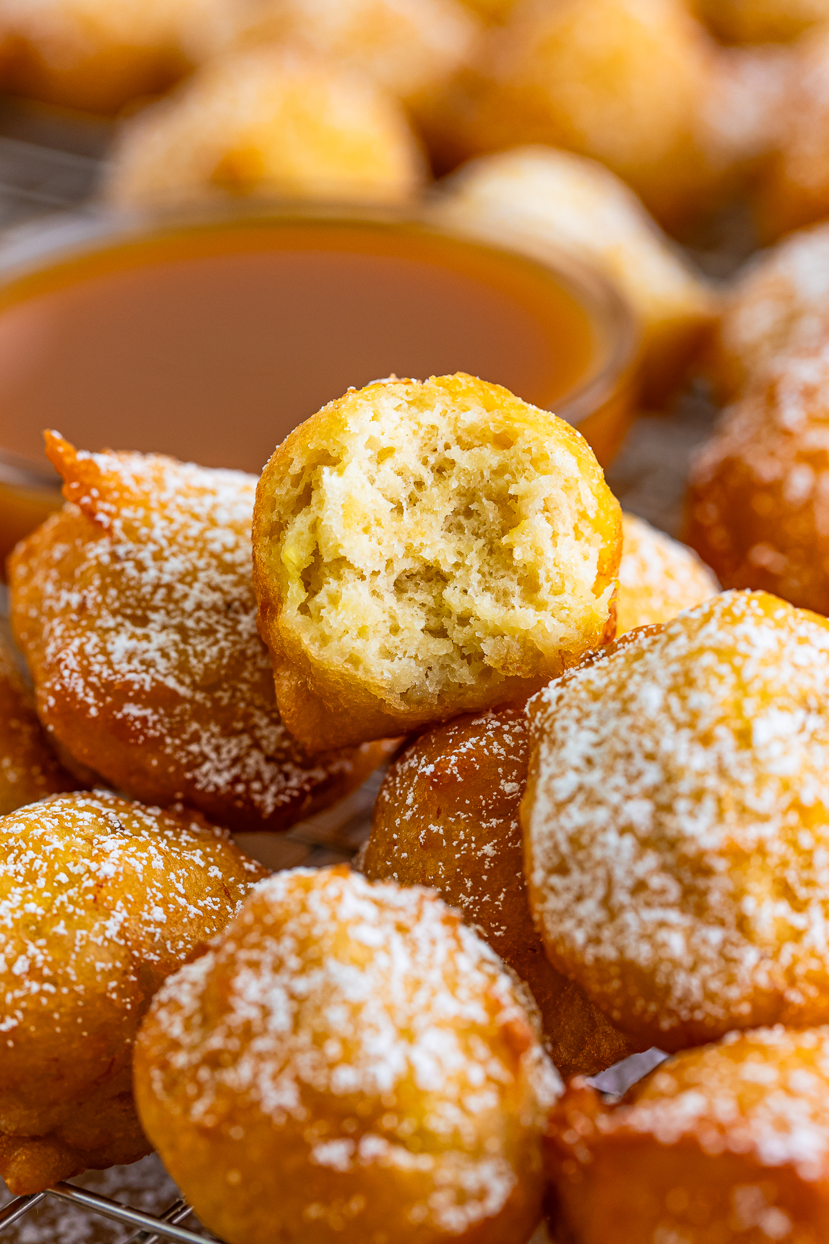 a stack of Banana Fritters with a bite taken out of the one on top