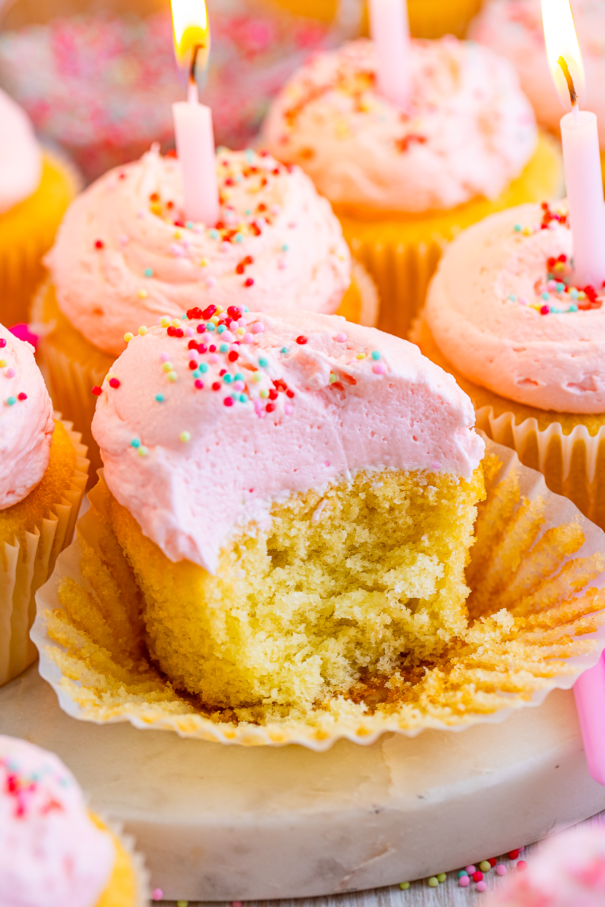 Birthday Cupcakes with a bite taken out, up close image