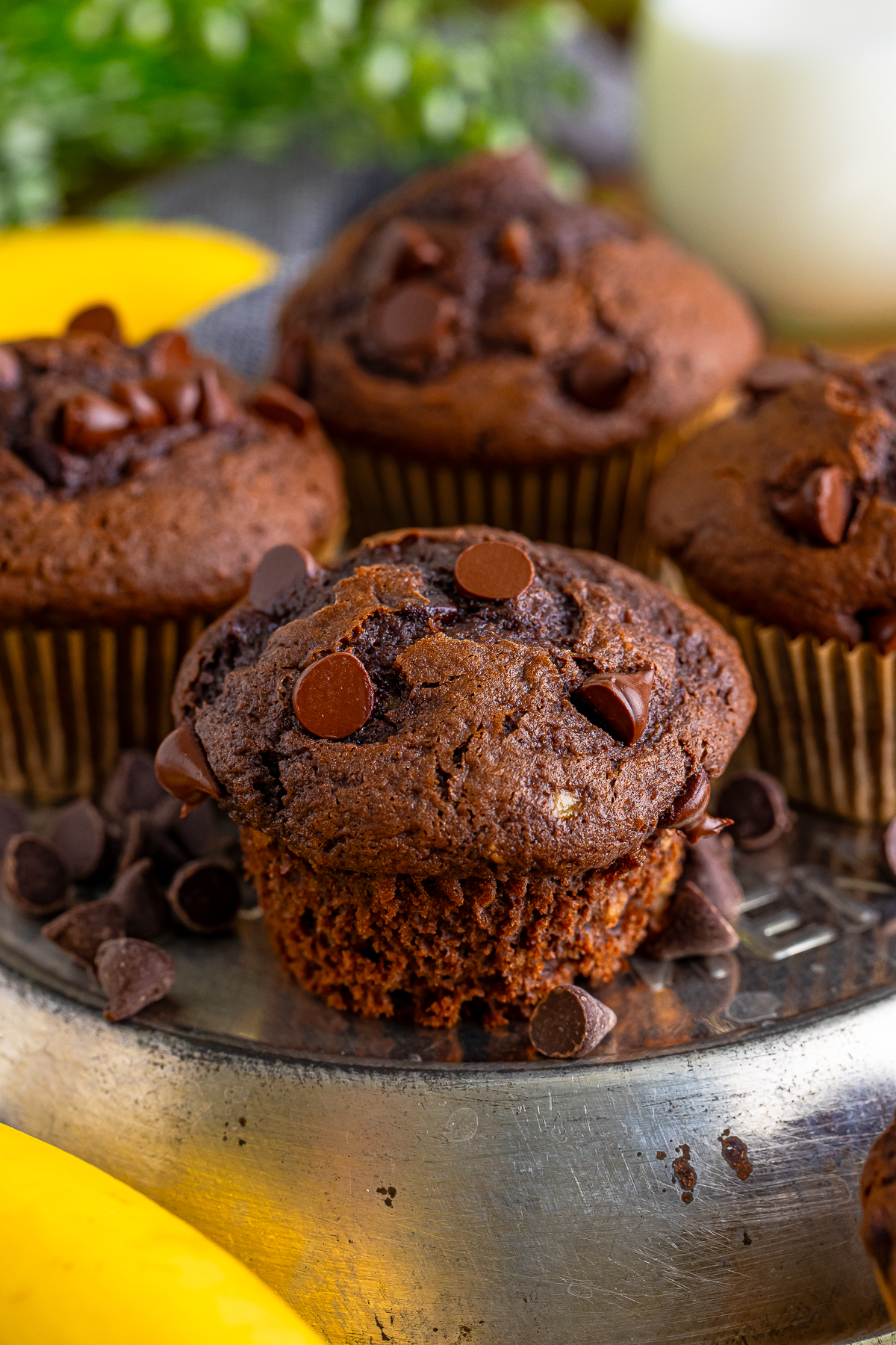 Chocolate Banana Chocolate Chip Muffins without the liner on a metal tray
