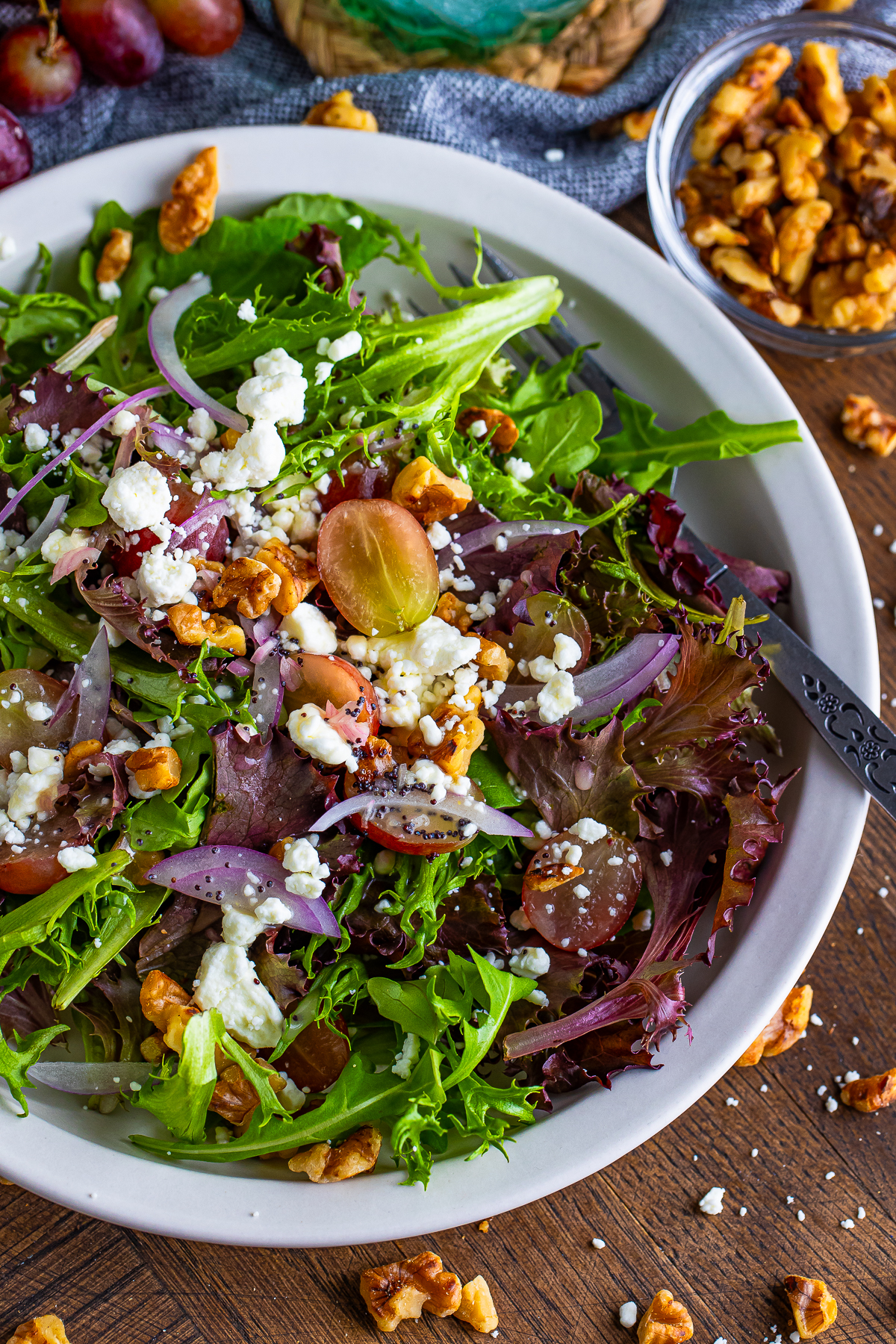 up close overhead shot of finished Goat Cheese Salad on a plate with garnishes