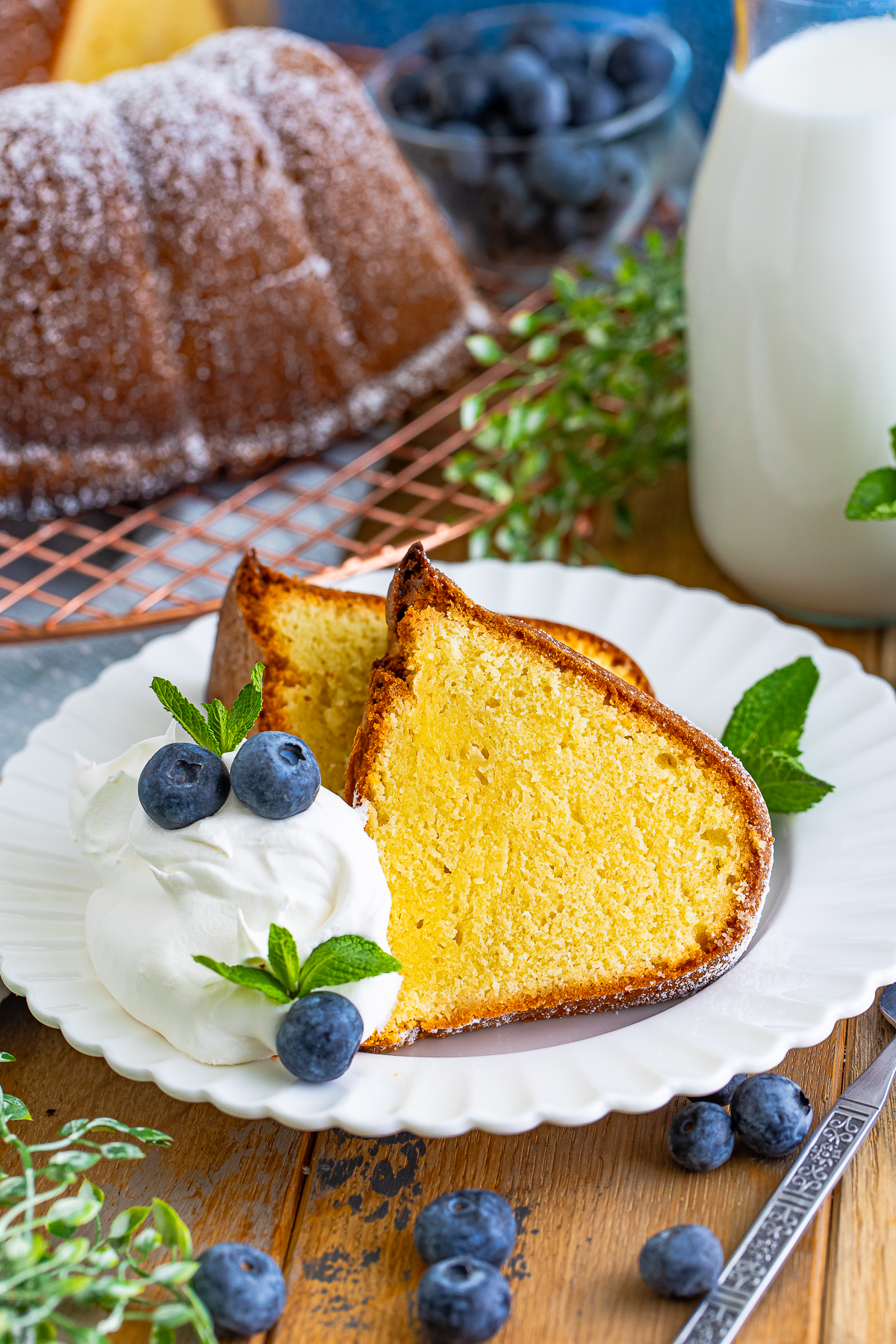 farther away image of two slices of Pound Cake on a plate with garnishes
