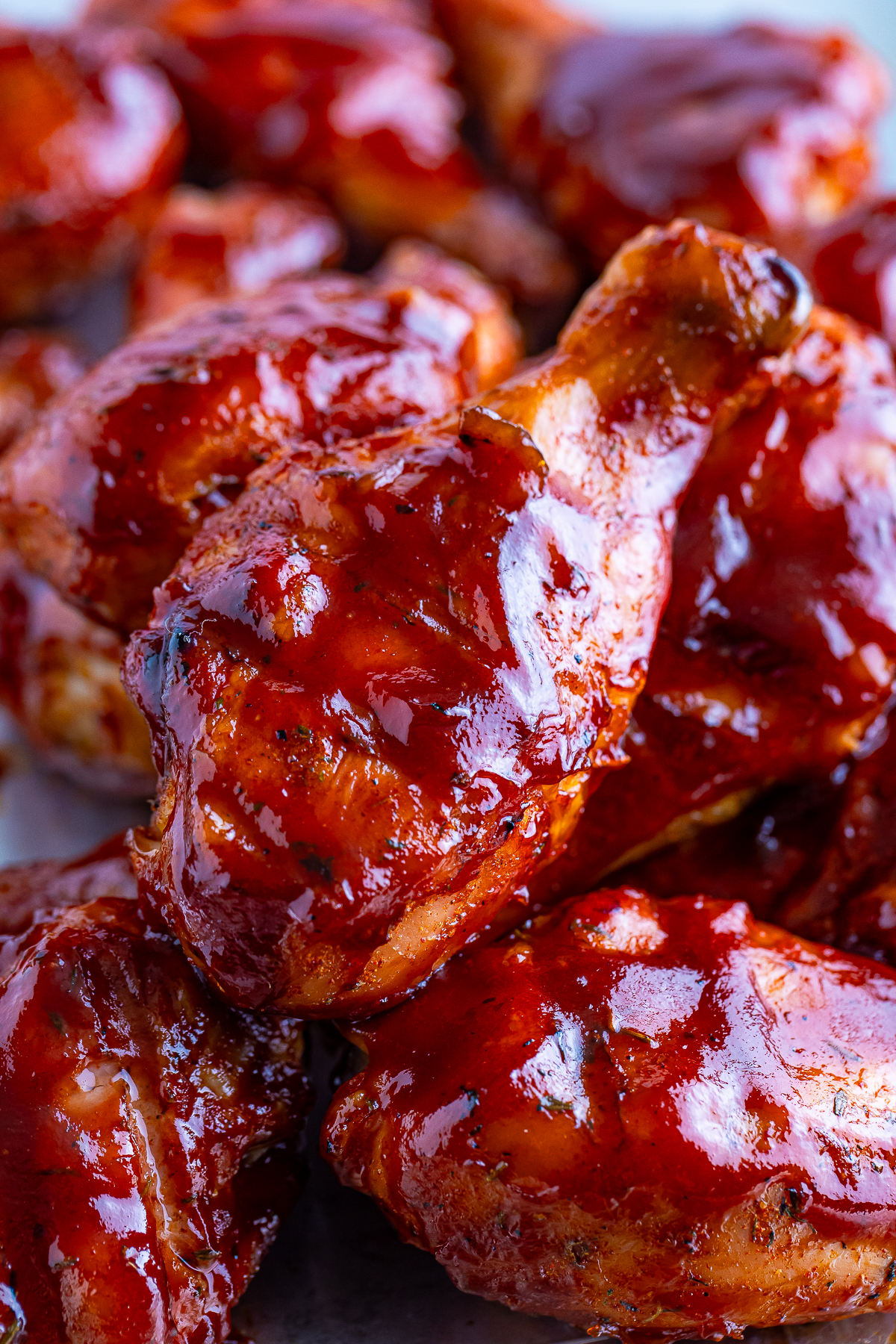 Smoked Chicken Legs stacked on top of each other on a tray