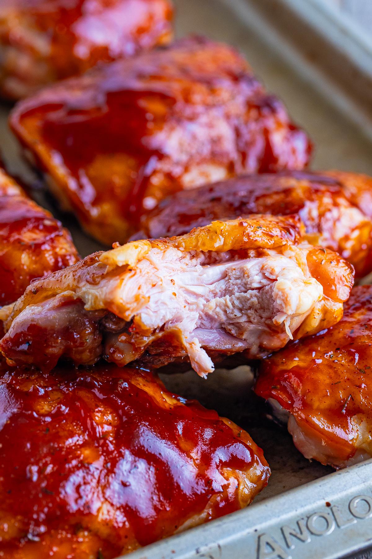 a bite taken out of Smoked Chicken Thighs to show the interior