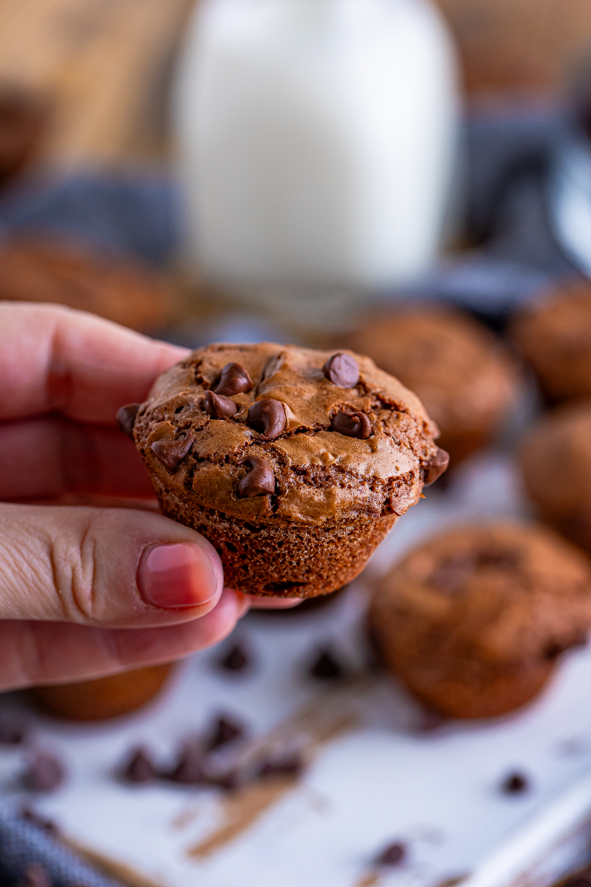 a hand holding up 2 Bite Brownies in air