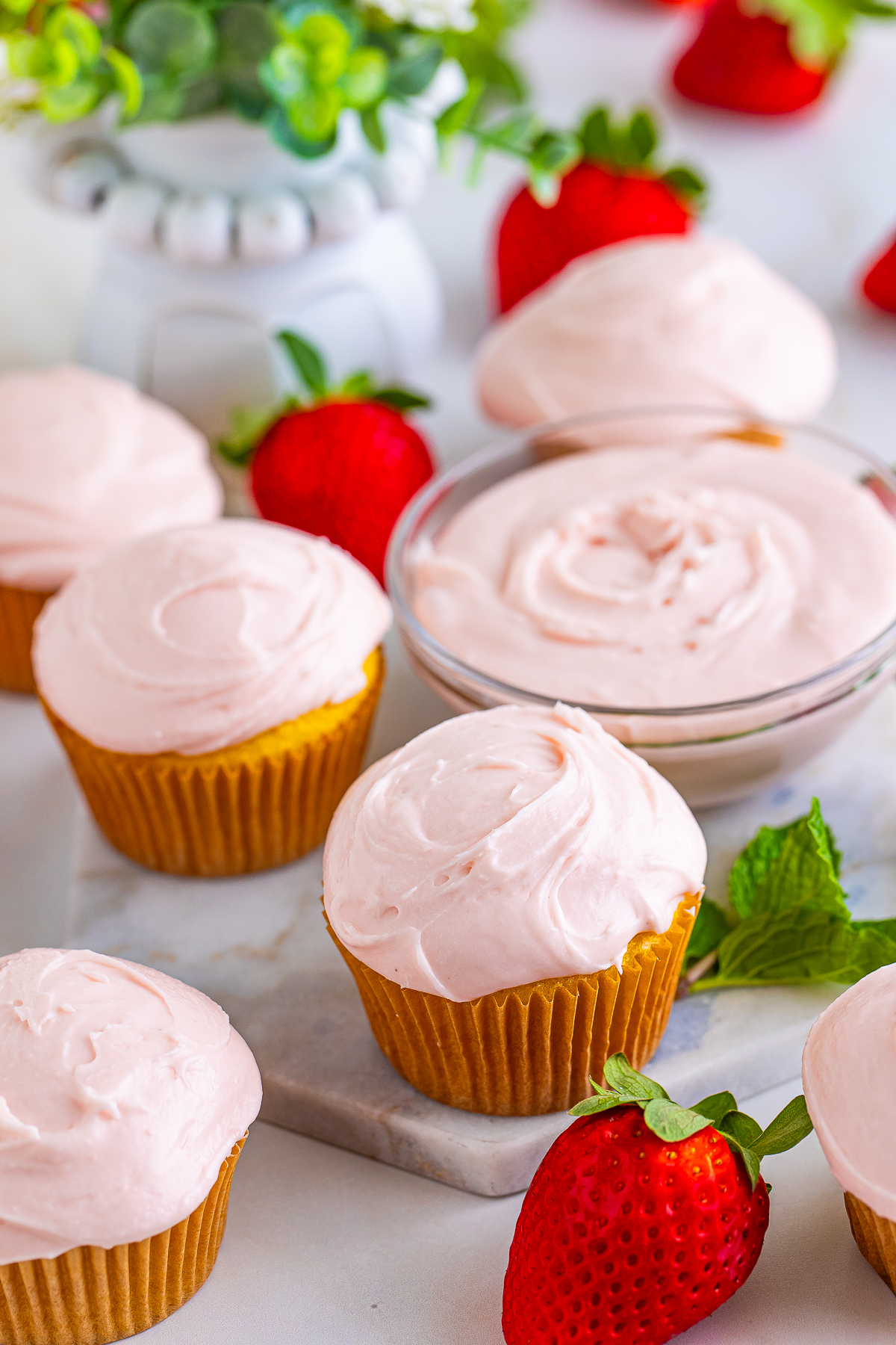 lots of cupcakes topped with Strawberry Cream Cheese Frosting