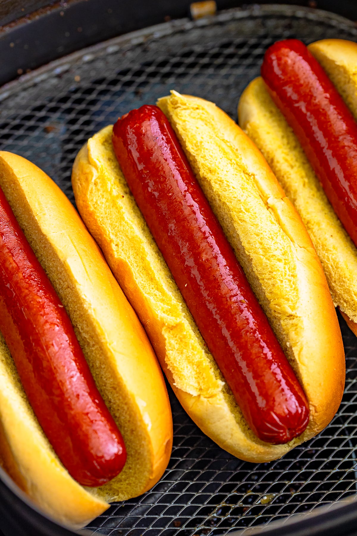 close up overhead image of finished Air Fry Hot Dogs in basket