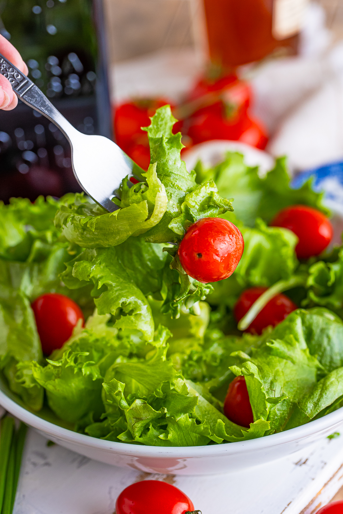 a fork holding up a bite of salad that has Apple Cider Vinegar Dressing on it