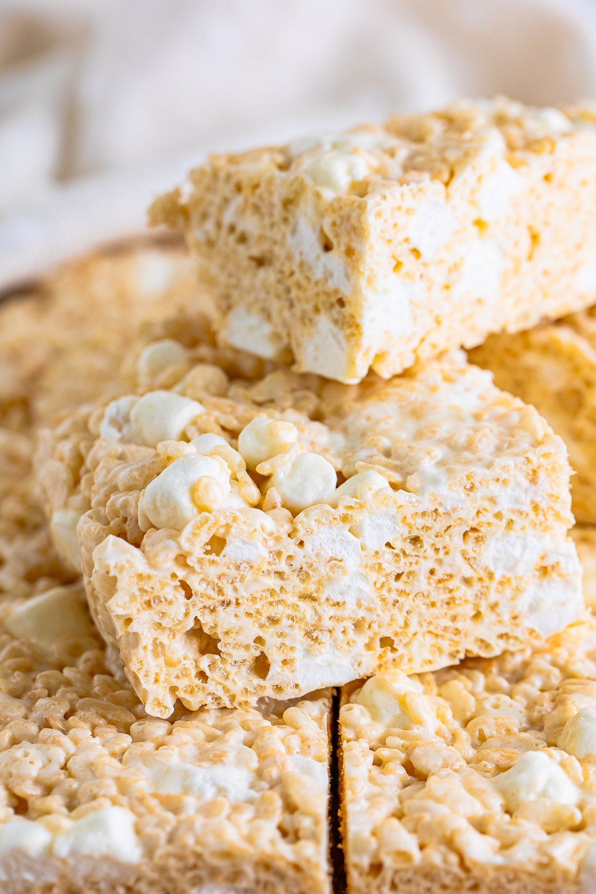 Brown Butter Rice Crispy Treats stacked on top of each other