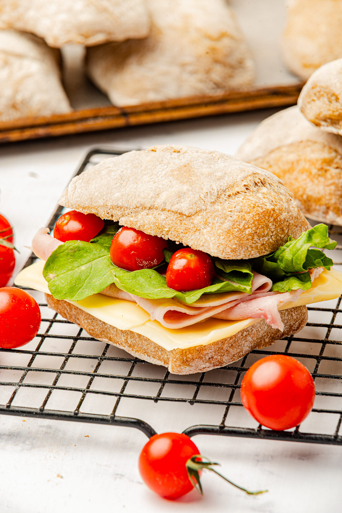 a sandwich on a wire rack made with Ciabatta Bread Rolls