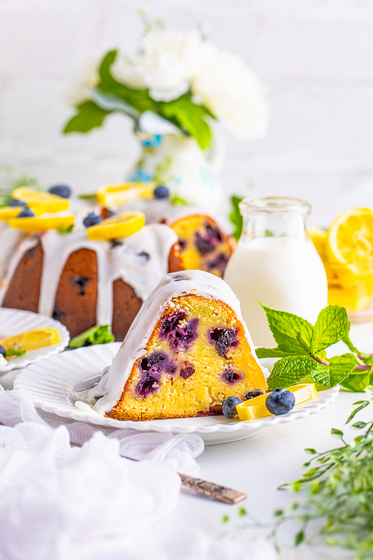 a slice of lemon blueberry pound cake on a white plate