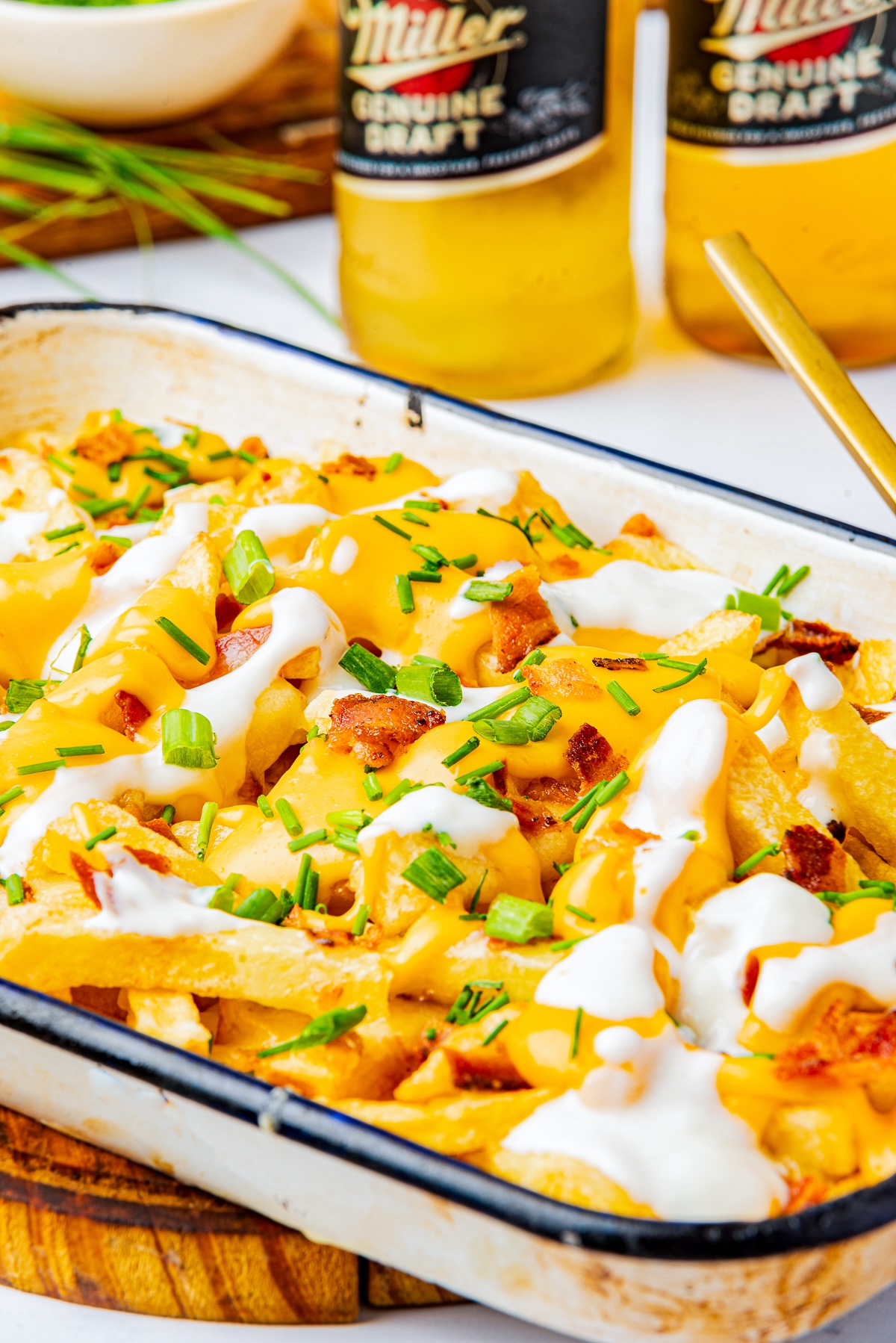 Loaded French Fries served in a baking dish with beers